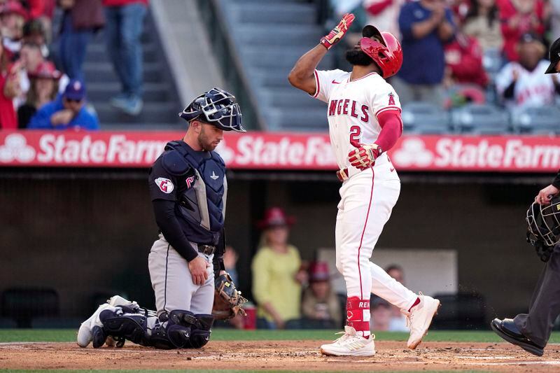 Los Angeles Angels' Luis Rengifo, right, gestures as he scores after hitting a solo home run as Cleveland Guardians catcher David Fry kneels at the plate during the first inning of a baseball game Friday, May 24, 2024, in Anaheim, Calif. (AP Photo/Mark J. Terrill)