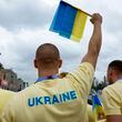 Ukraine's athletes stand on a boat ahead of the opening ceremony for the 2024 Summer Olympics on the Seine River in Paris, France, Friday, July 26, 2024. (Clodagh Kilcoyne/Pool Photo via AP)