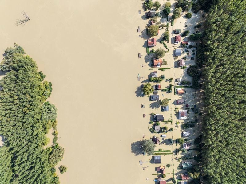 An aerial picture taken with a drone shows the flooded resort village of Venek and the swollen Danube River near Gyor, Hungary, Tuesday, September 17, 2024. (Gergely Janossy/MTI via AP)