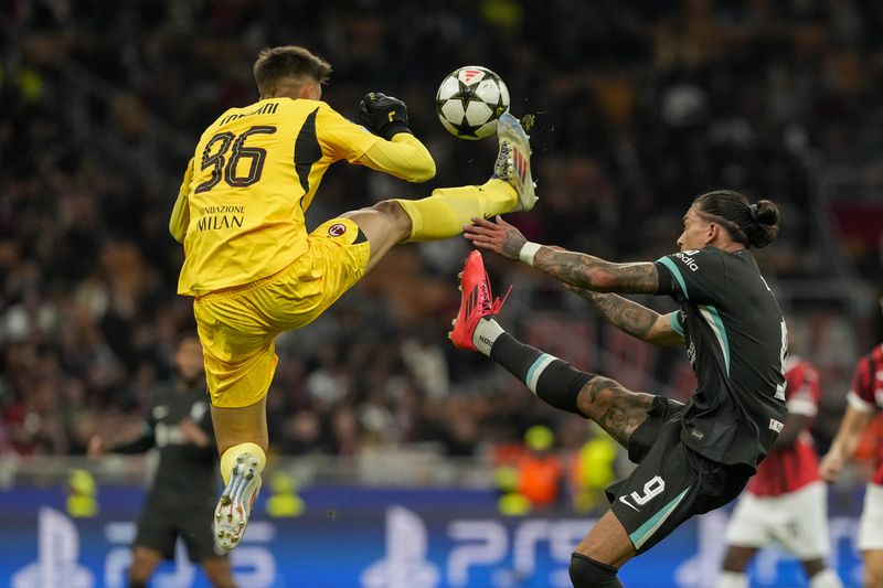 Liverpool's Darwin Nunez, right, and AC Milan's goalkeeper Lorenzo Torriani fight for the ball during the Champions League opening phase soccer match between AC Milan and Liverpool at the San Siro stadium in Milan, Italy, Tuesday, Sept. 17, 2024. (AP Photo/Luca Bruno)