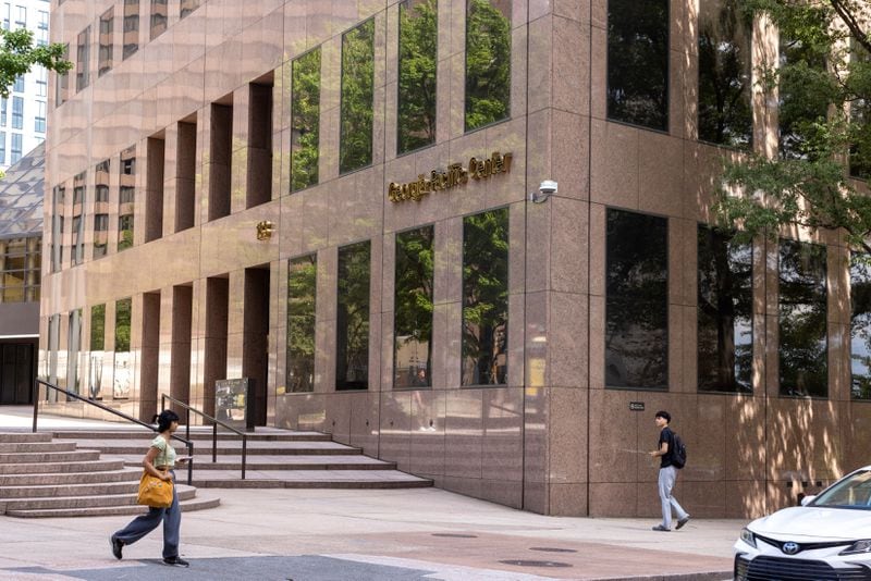 People walk past the Georgia-Pacific building in Atlanta on Wednesday, Sept. 18, 2024. Georgia-Pacific is converting their office tower in downtown Atlanta into a 51-story mixed-use building. (Arvin Temkar/AJC)