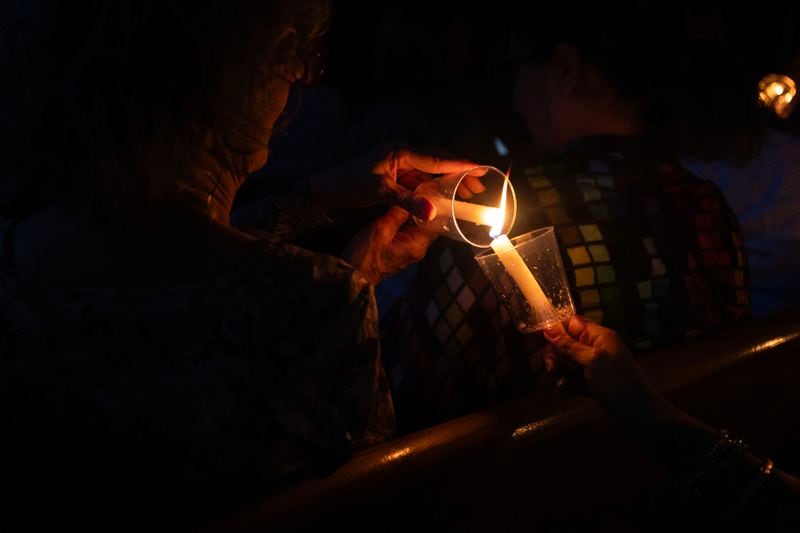 Guest light candles for each other after the lights went out during the Drag Me to Church event at St. Luke Lutheran on Sunday, 25, 2023 in Atlanta. (Michael Blackshire/Michael.blackshire@ajc.com)