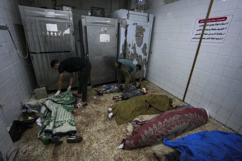 Palestinians killed in the Israeli bombardment of the Gaza Strip are laid in a morgue in Deir al Balah on Tuesday, June 4, 2024. (AP Photo/Abdel Kareem Hana)