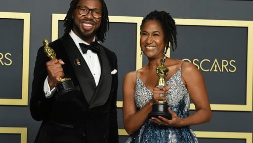 Matthew A. Cherry and Karen Rupert Toliver, winners of the award for Best Animated Short Film for "Hair Love," pose in the press room at the Oscars on Sunday.
