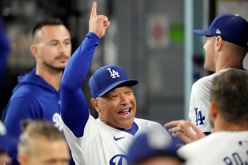 Los Angeles Dodgers manager Dave Roberts gestures to teammates prior to a baseball game against the San Diego Padres, Tuesday, Sept. 24, 2024, in Los Angeles. (AP Photo/Mark J. Terrill)