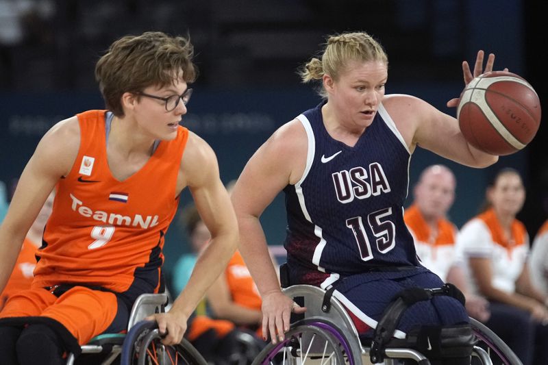 Rose Hollerman (right) of the United States and Bo Kramer of the Netherlands play during the gold medal game for women's wheelchair basketball between the Netherlands and the United States at the 2024 Paralympic Games in Paris, France, Sunday, Sept. 8, 2024. (AP Photo/Christophe Haenah)