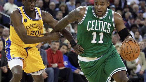 FILE - Boston Celtics' Glen Davis, right, drives the ball past Golden State Warriors' Ekpe Udoh (20) during the first half of an NBA basketball game, Feb. 22, 2011, in Oakland, Calif. (AP Photo/Ben Margot, File)