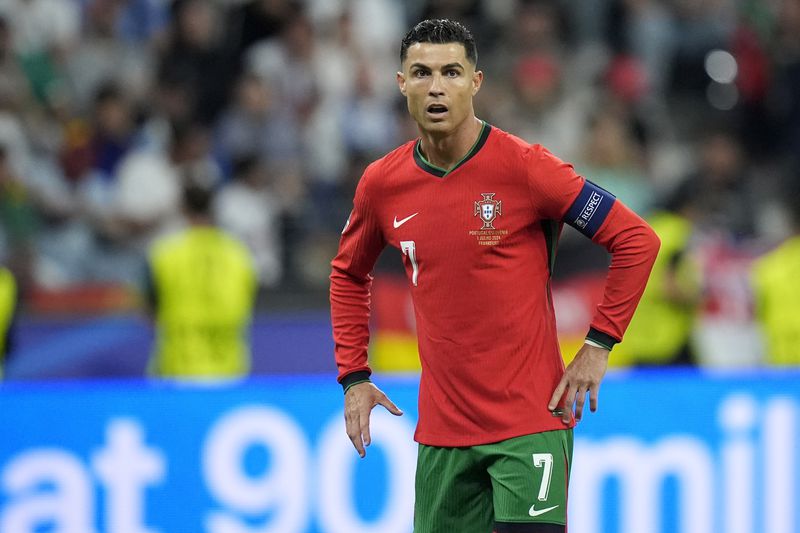 FILE - Portugal's Cristiano Ronaldo during a round of sixteen match between Portugal and Slovenia at the Euro 2024 soccer tournament in Frankfurt, Germany, Monday, July 1, 2024. Cristiano Ronaldo vs. Kylian Mbappé is not just a clash of soccer icons but a clash of generations. They’ll go head to head when Portugal plays France in the Euro 2024 quarterfinals on Friday and their heavyweight meeting just got a little bit bigger after Ronaldo said this would be his last European Championship. (AP Photo/Matthias Schrader, File)