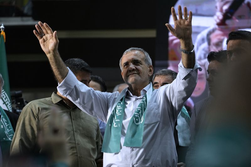Reformist candidate for Iran's presidential election Masoud Pezeshkian waves to his supporters in his campaign meeting in Tehran, Iran, Sunday, June 23, 2024. (AP Photo/Vahid Salemi)