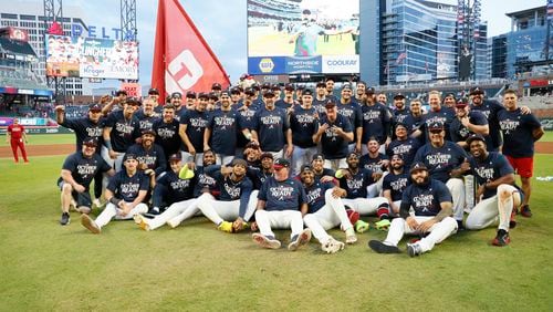 The Braves pose for a team photograph after earning a spot in the playoffs by beating the Mets 3-0 in the second game of the doubleheader at Truist Park on Monday, Sept. 30, 2024, in Atlanta. 
(Miguel Martinez/ AJC)