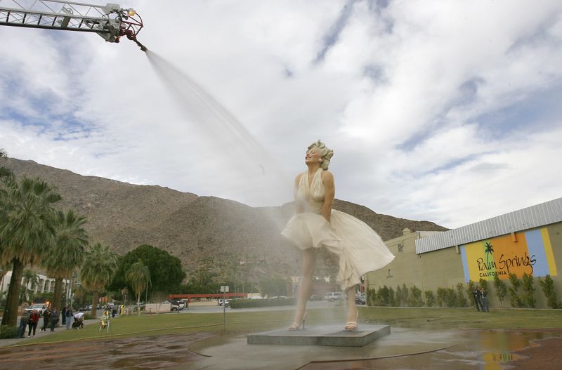FILE - The "Forever Marilyn" sculpture gets a shower from the Palm Springs Fire Department on Wednesday, Jan. 23, 2013 in Palm Springs, Calif. The Los Angeles City Council voted to declare the home where Marilyn Monroe briefly lived and died a historic cultural monument in order to save it from demolition by its owners. (Jay Calderon/The Orange County Register via AP, file)