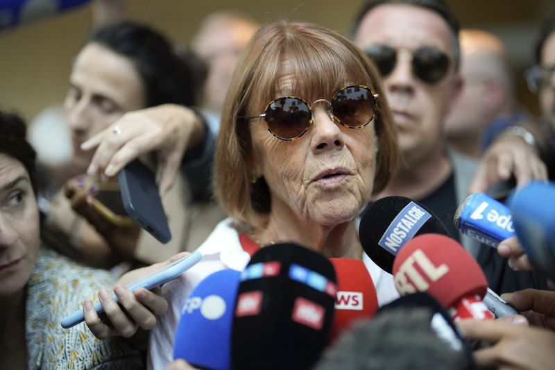 Gisele Pelicot speaks to media as she leaves the Avignon court house, southern France, Thursday, Sept. 5, 2024. A woman allegedly drugged by her ex-husband so that she could be raped by other men while she laid unconscious, is expected to testify before a panel of French judges. (AP Photo/Lewis Joly)