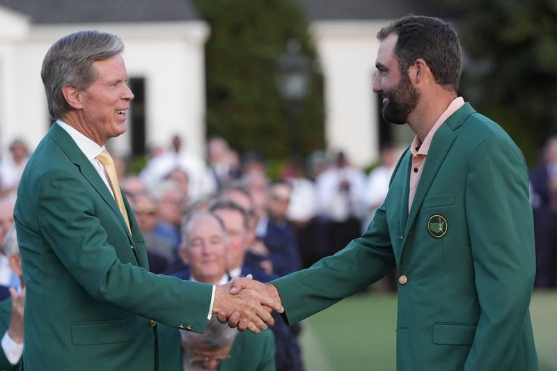 FILE - Fred Ridley, chairman of Augusta National Golf Club, shakes hands with Winner Scottie Scheffler at the Masters golf tournament at Augusta National Golf Club Sunday, April 14, 2024, in Augusta, Ga. (AP Photo/David J. Phillip, File)