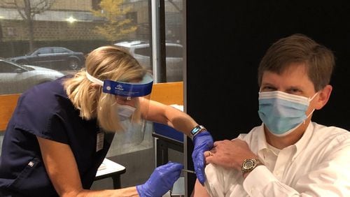 David W. Kimberlin, M.D., a professor of pediatrics in the division of pediatric infectious diseases at the University of Alabama at Birmingham, receives his first dose of COVID-19 vaccine in December 2020, shortly after losing his father to the virus.