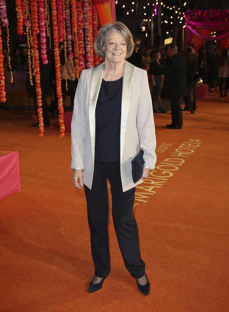 FILE - ACtress Maggie Smith appears at the World Premiere of "The Second Best Exotic Marigold Hotel" at a central London cinema in Leicester Square, on Feb. 17, 2015. Smith, who won an Oscar for “The Prime of Miss Jean Brodie” in 1969 and won new fans in the 21st century as the dowager Countess of Grantham in “Downton Abbey,” has died at 89. (Photo by Joel Ryan/Invision/AP, File)