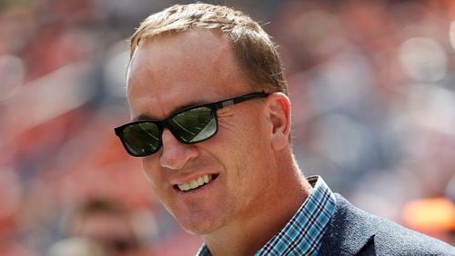 In this Sept. 16, 2018, file photo, former Denver Broncos quarterback Peyton Manning watches prior to an NFL football game against the Oakland Raiders, in Denver. Just as he had the true touch when he threw passes, set records and won two Super Bowls on the field, Peyton Manning possesses the right approach to look back at some of the NFLs greatest moments. Manning, a lock for the Pro Football Hall of Fame when he becomes eligible in 2021, is hosting and serves as one of the executive producers for Peytons Places, a five-part, 30-episode series that celebrates the NFLs 100th season.(AP Photo/Jack Dempsey, File)