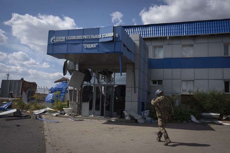 A Ukrainian soldier approaches a gas metering station of Russian energy giant Gazprom in Sudzha, Kursk region, Russia, Friday, Aug. 16, 2024. This image was approved by the Ukrainian Defense Ministry before publication. (AP Photo)