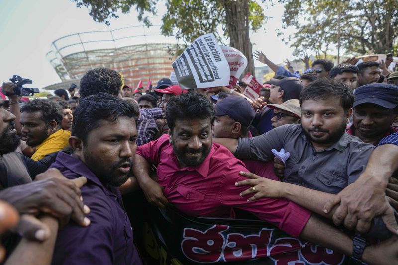 Anura Kumara Dissanayake, center, leader of opposition political party National People's Power attends a protest rally in Colombo, Sri Lanka, Sunday, Feb. 26, 2023. (AP Photo/Eranga Jayawardena, File)