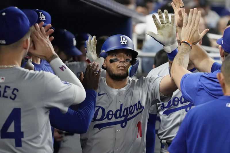 Los Angeles Dodgers' Miguel Rojas (11) celebrates after hitting a home run during the fourth inning of a baseball game against the Miami Marlins, Tuesday, Sept. 17, 2024, in Miami. (AP Photo/Marta Lavandier)