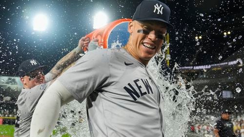 New York Yankees' Aaron Judge is doused by his teammates after he hit his 300th career home run, the fastest player to do so in MLB history, in a baseball game against the Chicago White Sox, Wednesday, Aug. 14, 2024, in Chicago. (AP Photo/Erin Hooley)