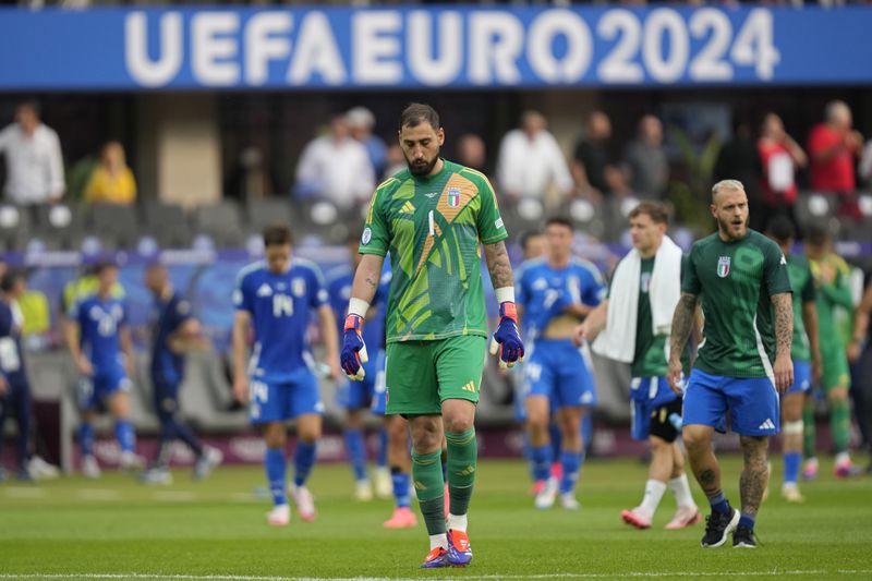 Italy's goalkeeper Gianluigi Donnarumma walks off at the end of a round of sixteen match between Switzerland and Italy at the Euro 2024 soccer tournament in Berlin, Germany, Saturday, June 29, 2024. Switzerland won the game 2-0. (AP Photo/Ariel Schalit)