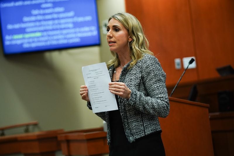 Defense attorney Amanda Clark Palmer holds up a jury verdict form while giving her closing arguments during day five of the Robert "Chip" Olsen murder trial at the DeKalb County Courthouse on October 3, 2019 in Decatur. Olsen is charged with murdering war veteran Anthony Hill. (Elijah Nouvelage for The Atlanta Journal-Constitution)