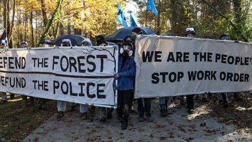 Protesters march against Atlanta's planned police and firefighter safety training center in an event organizers are calling a non-violent "Day of Action." (Riley Bunch / Riley.Bunch@ajc.com)