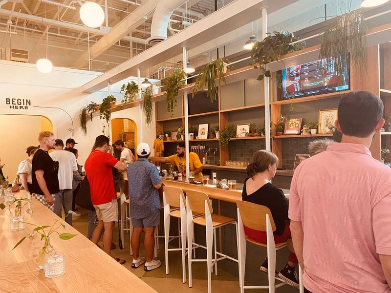 Elsewhere Brewing’s second location, called The Greenhouse, features a cozy atmosphere with house plants and vinyl records spinning behind the bar. 
(Bob Townsend for the Atlanta Journal Constitution)