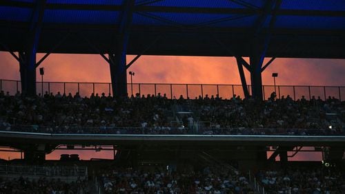 People at the upper deck enjoyed a sunset at Truist Park on Friday, July 5, 2024 in Atlanta. (Hyosub Shin / AJC)