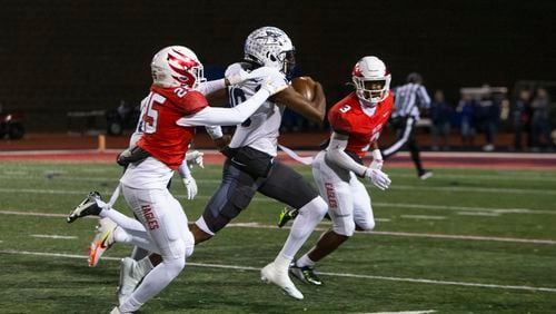 Arrington (AJ) Watkins, quarterback for Norcross, runs the ball and gets tackled by Dylan Lewis, cornerback for Norcross, during the Milton vs. Norcross high school football game on Friday, November 18, 2022, at Milton high school in Milton, Georgia. Milton defeated Norcross 30-23. CHRISTINA MATACOTTA FOR THE ATLANTA JOURNAL-CONSTITUTION.