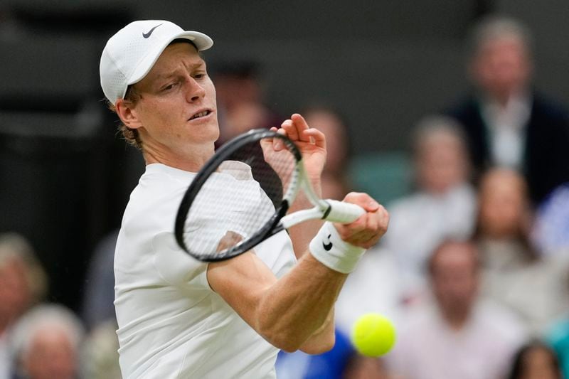 Jannik Sinner of Italy plays a forehand return to Daniil Medvedev of Russia during their quarterfinal match at the Wimbledon tennis championships in London, Tuesday, July 9, 2024. (AP Photo/Alberto Pezzali)