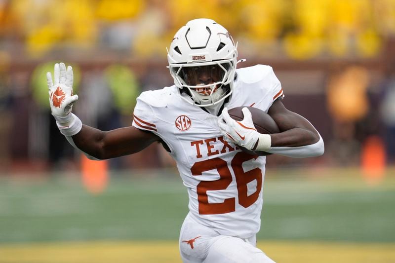 Texas running back Quintrevion Wisner runs against Michigan in the first half of an NCAA college football game in Ann Arbor, Mich., Saturday, Sept. 7, 2024. (AP Photo/Paul Sancya)