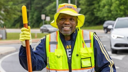 Anthony "Spark Plug" Thomas cleans up litter and debris at the Highway 92 traffic circle at Antioch and Lockwood roads in Fayetteville. He is a nationally recognized motivational speaker and U.S. Navy Veteran based in Fayetteville, Georgia, is making waves with his commitment to community cleanliness. PHIL SKINNER FOR THE ATLANTA JOURNAL-CONSTITUTION