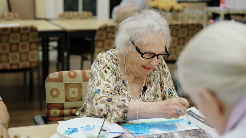 Lillian Mortimer, who is 107 years old, said the easiest thing to do at her age is to remain stagnant. But to thrive, she said she stays active in the assisted living facility where she lives in the Marietta area. One of her favorite activities lately: taking painting classes for the first time in her life. (Robyn Hutson/AJC)