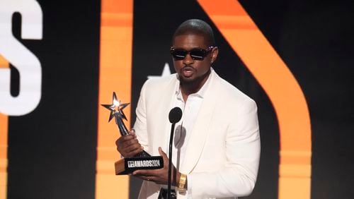 Usher accepts the award for best male R&B/pop artist during the BET Awards on Sunday, June 30, 2024, at the Peacock Theater in Los Angeles. (AP Photo/Chris Pizzello)