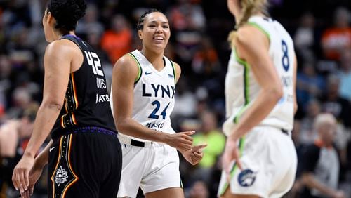 Minnesota Lynx forward Napheesa Collier (24) smiles at forward Alanna Smith (8) during the second half of a WNBA basketball semifinal game against the Connecticut Sun, Friday, Oct. 4, 2024, in Uncasville, Conn. (AP Photo/Jessica Hill)