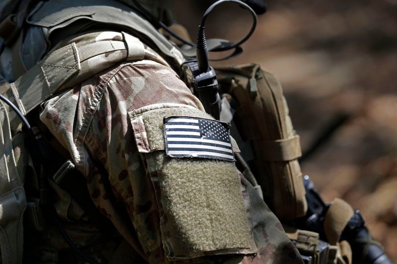 FILE - A U.S. flag patch adorns the uniform of a paratrooper, April 21, 2017, during a training exercise at Fort Bragg, N.C. Fifteen current or retired Joint Base Lewis-McChord servicemen who say the Army failed to protect them from a military doctor who's been charged with sexual abuse are seeking $5 million in damages for the emotional distress they say they've suffered. (AP Photo/Gerry Broome, File)