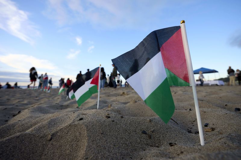 Palestinian flags are seen during a vigil on Alki Beach for Aysenur Ezgi Eygi, a 26-year-old activist from Seattle, who was killed recently in the West Bank, Wednesday, Sept. 11, 2024, in Seattle. (AP Photo/John Froschauer)