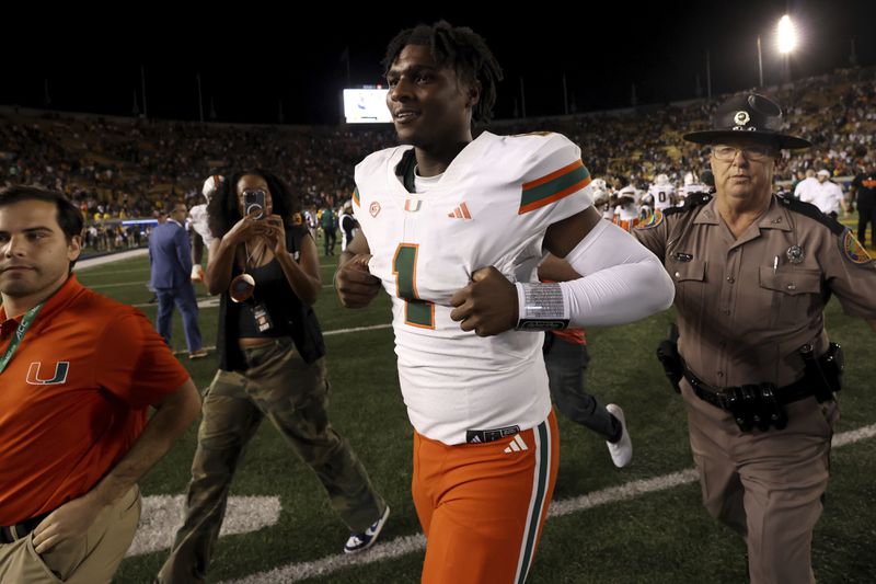 Miami quarterback Cam Ward (1) celebrates after defeating California during an NCAA college football game in Berkeley, Calif., Saturday, Oct. 5, 2024. (AP Photo/Jed Jacobsohn)