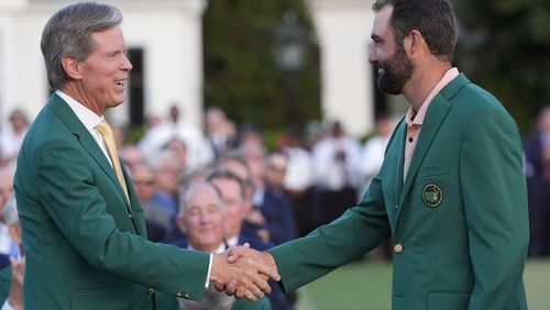 FILE - Fred Ridley, chairman of Augusta National Golf Club, shakes hands with Winner Scottie Scheffler at the Masters golf tournament at Augusta National Golf Club Sunday, April 14, 2024, in Augusta, Ga. (AP Photo/David J. Phillip, File)