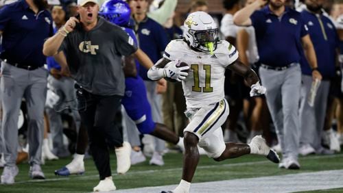 Georgia Tech Yellow Jackets running back Jamal Haynes (11) runs for a long game, as Tech coach Brent Key watches, to set up Tech's second score in a NCAA football game between the Georgia State Panthers and Georgia Tech at Bobby Dodd Stadium in Atlanta on Saturday, Aug. 31, 2024.  (Bob Andres for The Atlanta Journal-Constitution)