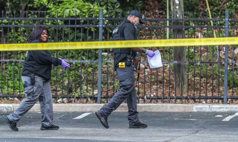 Crime scene tape is strung across the parking lot at the Flipper Temple Apartments on Thursday after a man was fatally shot. 