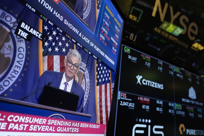 A screen displays a news conference with Federal Reserve Chairman Jerome Powell on the floor at the New York Stock Exchange in May. The Fed's rate-setting committee meets this week. (AP Photo/Seth Wenig, File)