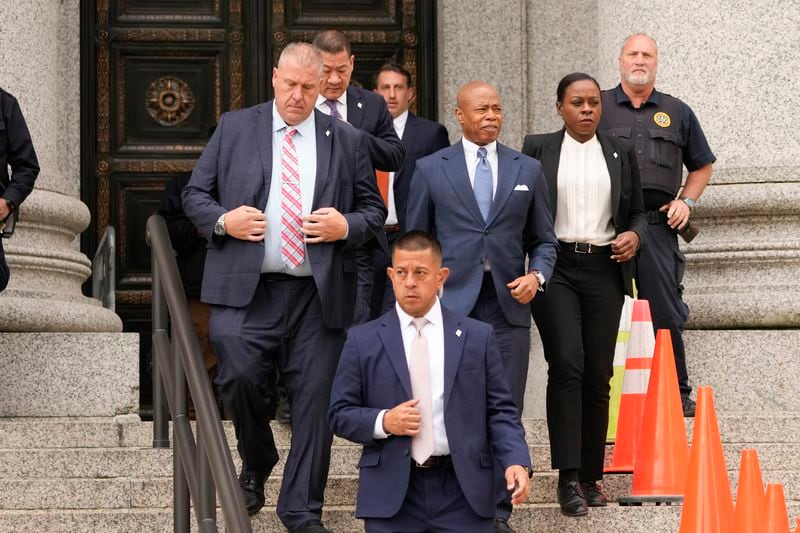 New York City Mayor Eric Adams, center, leaves the courthouse in New York, Wednesday, Oct. 2, 2024. (AP Photo/Seth Wenig)