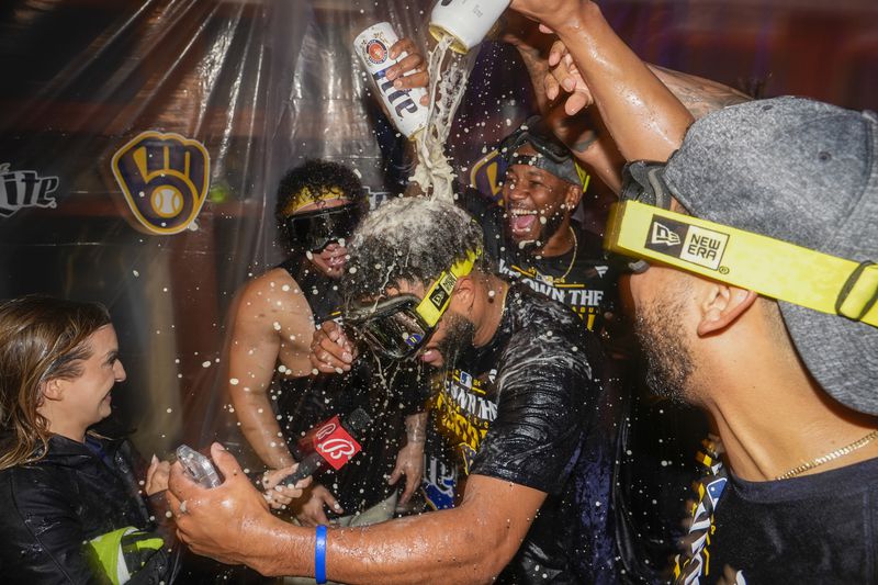 Milwaukee Brewers' Jackson Chourio is douced after a baseball game against the Philadelphia Phillies Wednesday, Sept. 18, 2024, in Milwaukee. The Brewers won 2-1 and clinched the National League Central division. (AP Photo/Morry Gash)