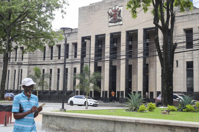 The country's coat of arms is displayed on the facade of a government building in Port-of-Spain, Trinidad and Tobago, Tuesday, Aug. 20, 2024. Prime Minister Keith Rowley announced on Sunday, Aug. 18, 2024, that the country is redrawing the island's coat of arms to remove references to European colonization, replacing Christopher Columbus' three ships with the steelpan, a popular percussion instrument. (AP Photo/Ash Allen)