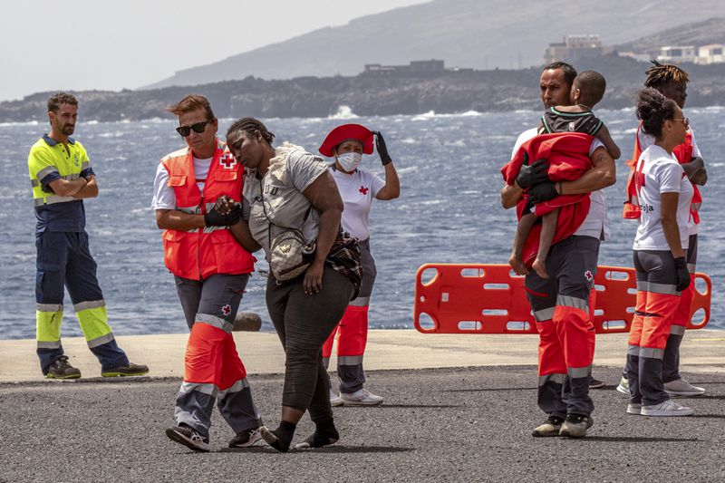 Migrants disembark at the port of "La Estaca" in Valverde at the Canary island of El Hierro, Spain, Monday, Aug. 26, 2024, after a thirteen-day voyage by boat from the coast of Senegal. (AP Photo/Maria Ximena)