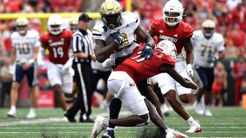 Georgia Tech wide receiver Avery Boyd (9) is hit by Louisville defensive back D'Angelo Hutchinson during the second half of an NCAA college football game in Louisville, Ky., Saturday, Sept. 21, 2024. (AP Photo/Timothy D. Easley)