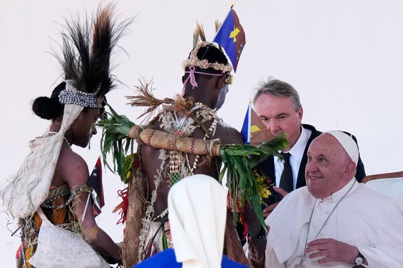 Pope Francis meets with people in traditional dress after giving an address during meeting with young people in the Sir John Guise Stadium in Port Moresby, Papua New Guinea, Monday, Sept. 9, 2024. (AP Photo/Mark Baker)