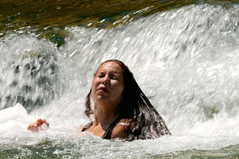 Leeann keeps cool in the Guadalupe River as temperatures in South Texas hit triple-digit numbers, Wednesday, Aug. 21, 2024, in New Braunfels, Texas. (AP Photo/Eric Gay)